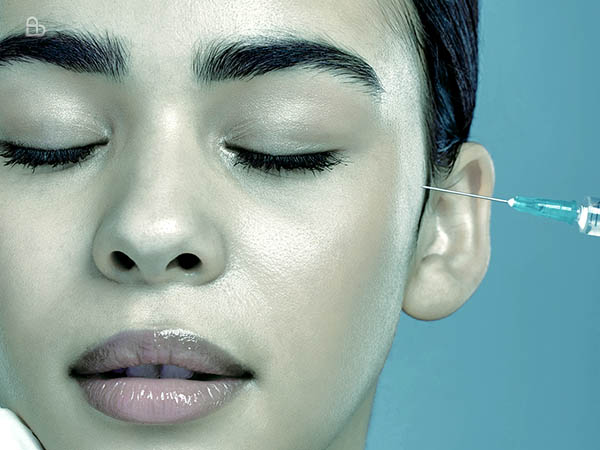 Dermatologist performing precise dermal filler treatment for natural facial contouring